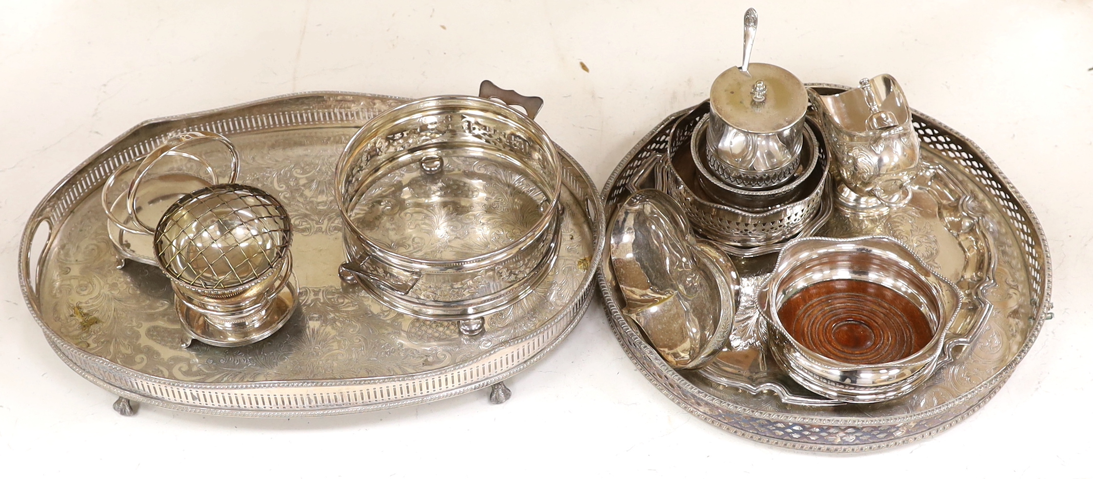 A quantity of silver plate including two trays with pierced galleries, a wine coaster, condiment serving pots, etc.